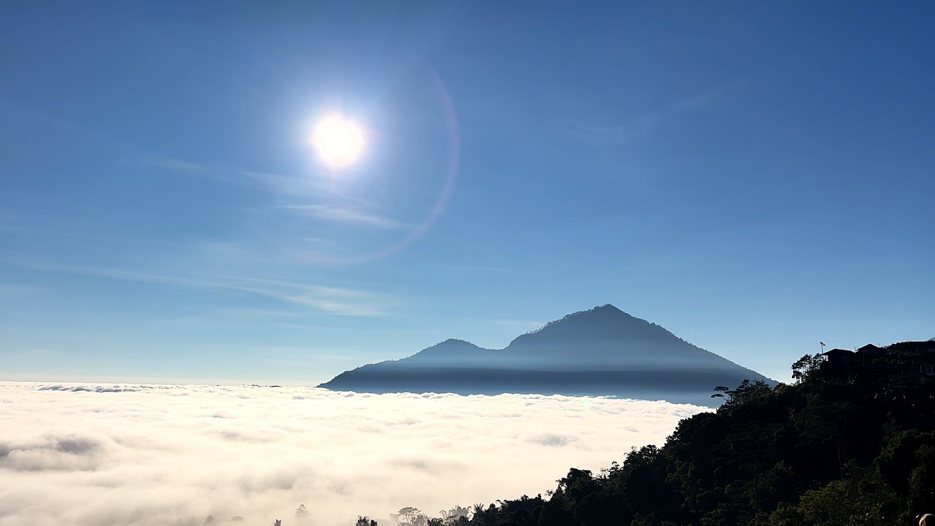 Volcano above a sea of clouds at sunrise in Bali